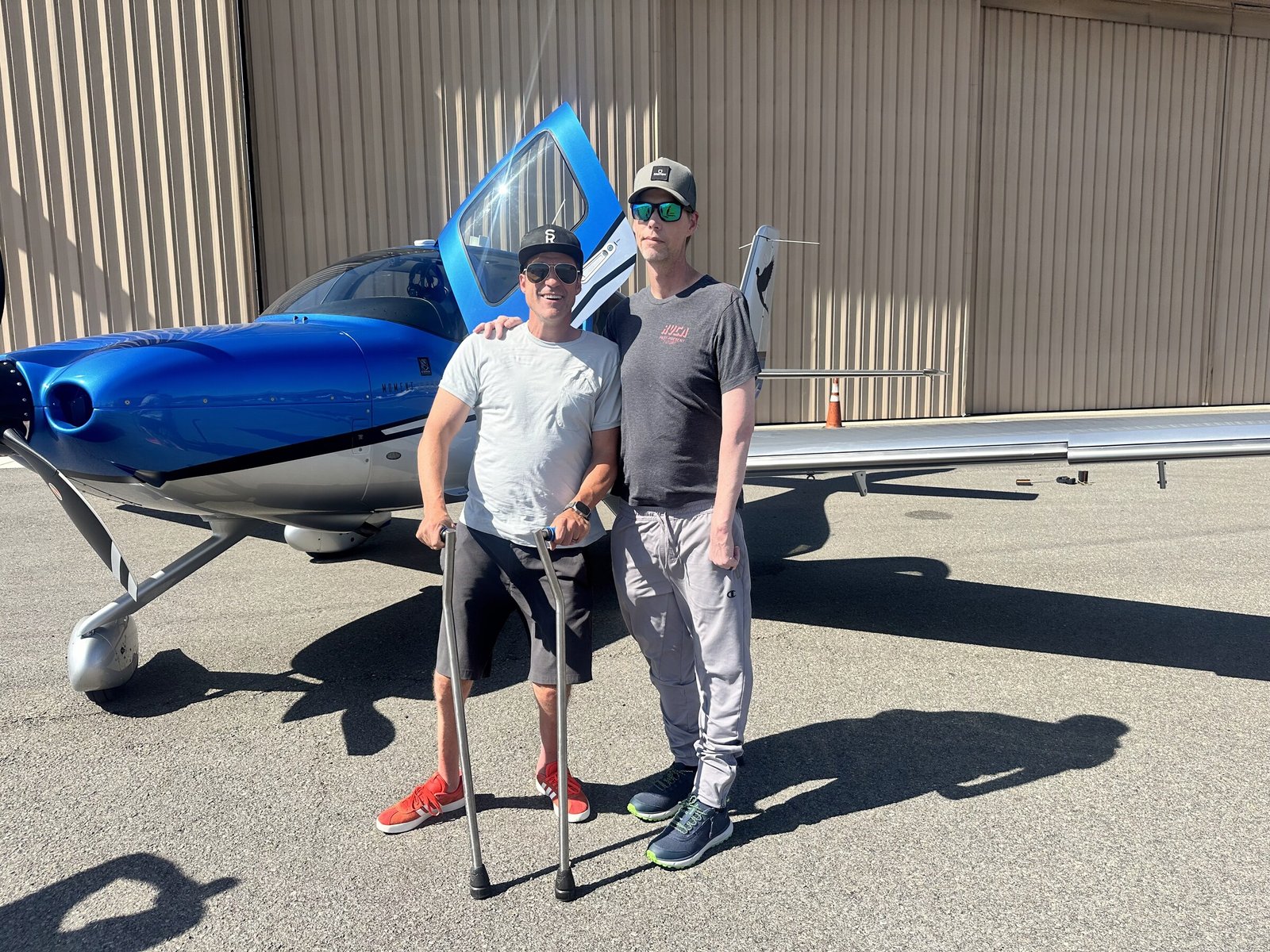 A hero with pilot Grant Korgan in front of the Moment Foundation aircraft at the hangar
